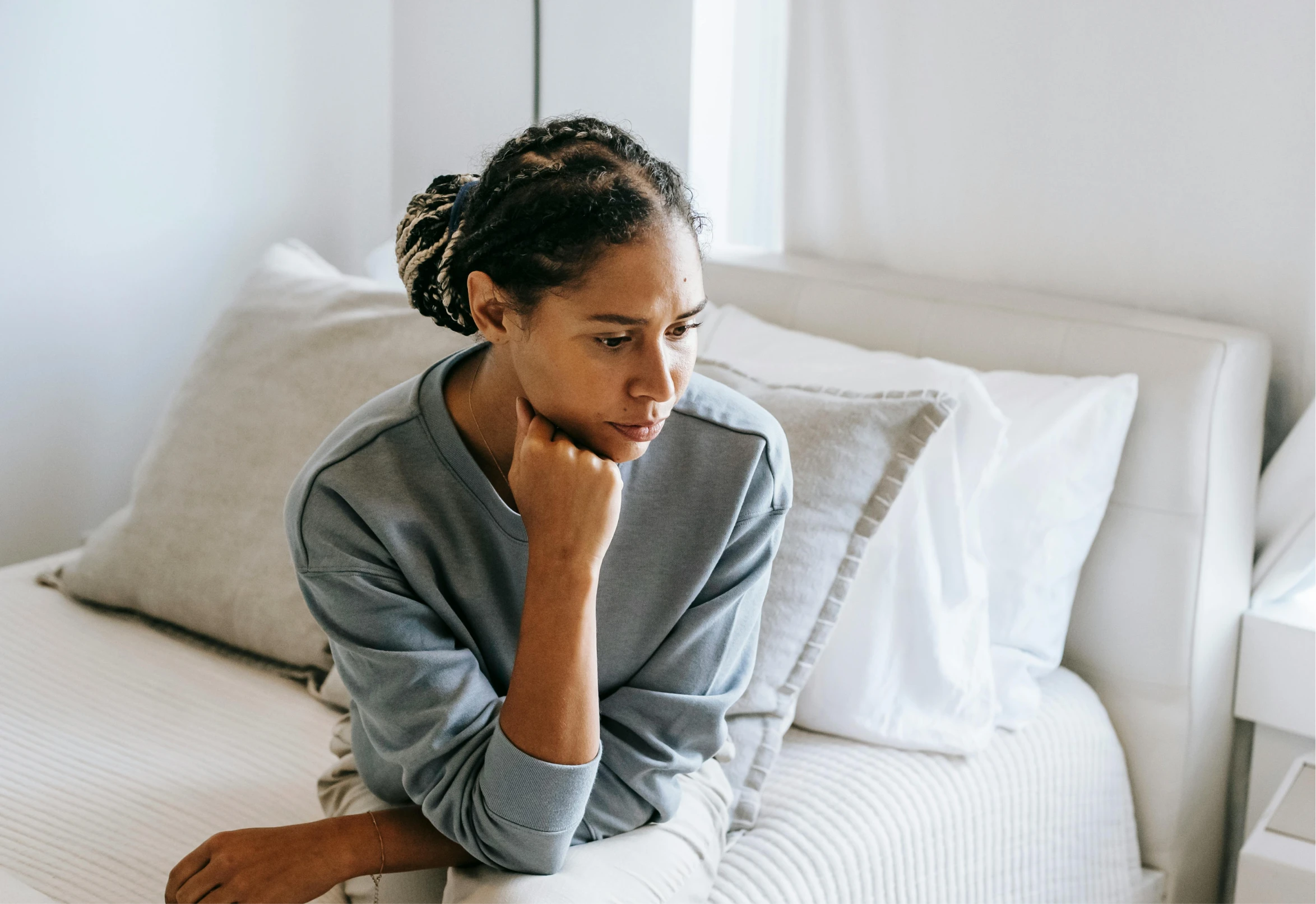 Woman sitting thoughtfully, seeking relief from pelvic pain