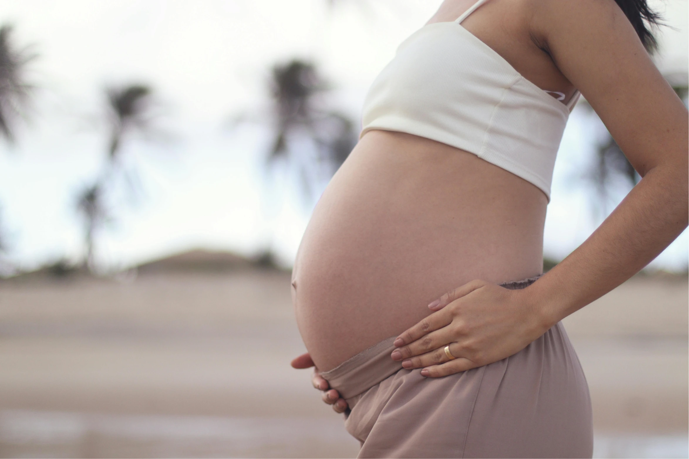 Expectant mother cradling her pregnant belly